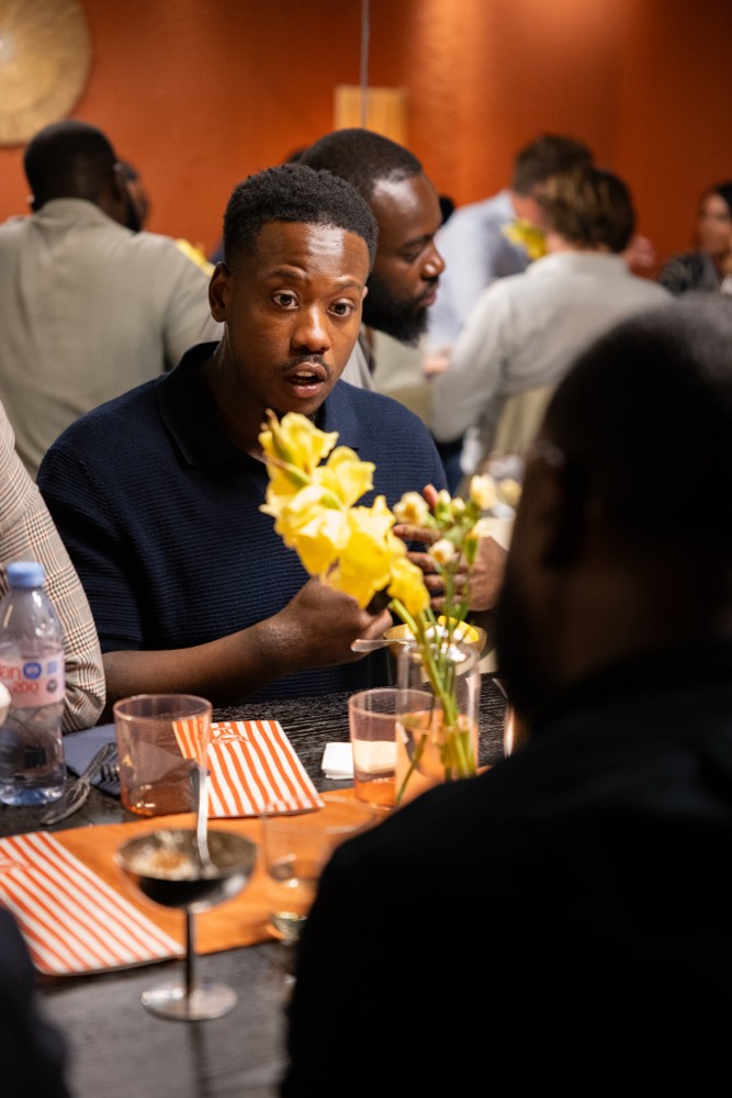 A founder listening intently at the dinner